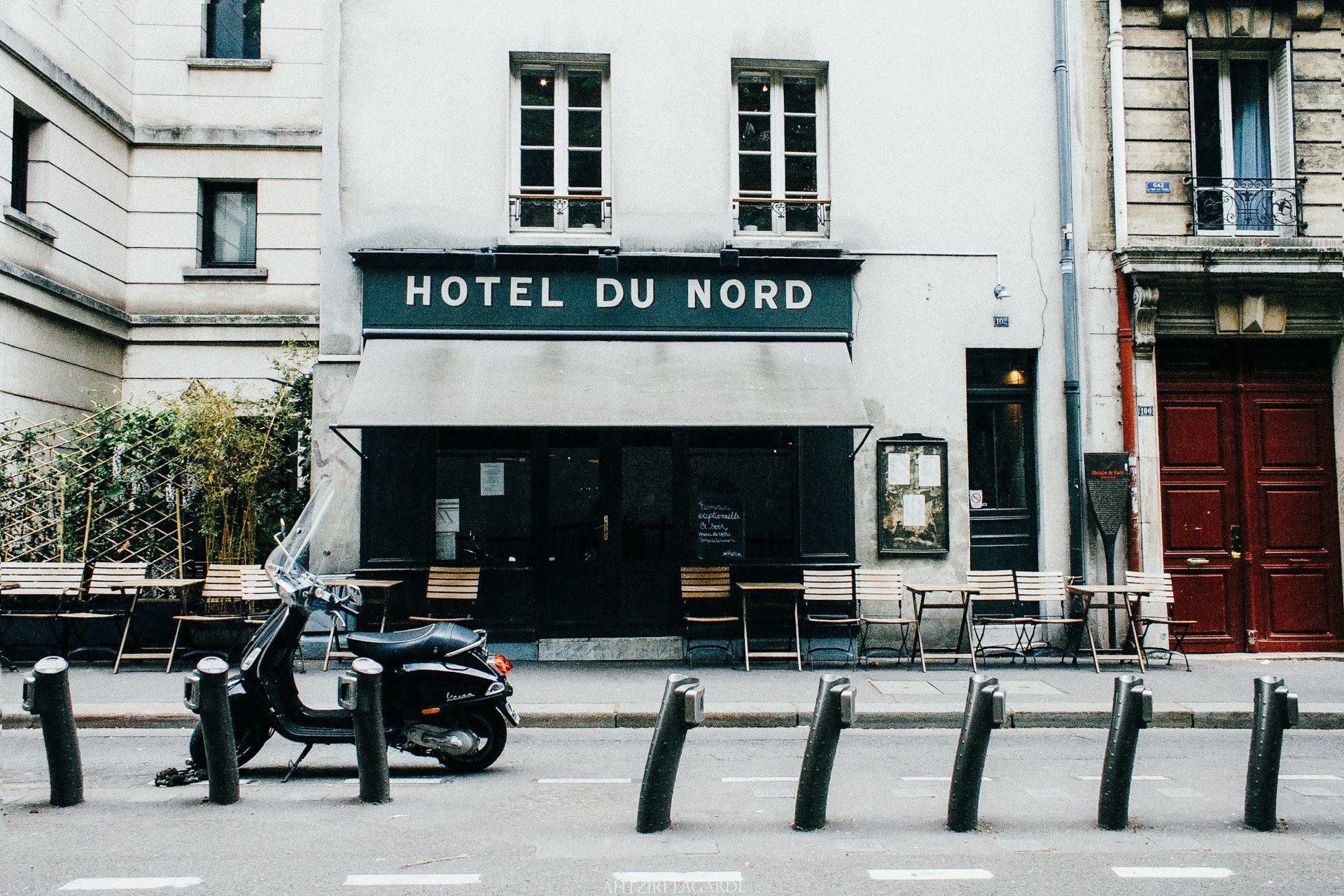 black motorcycle parked in front of white building during daytime